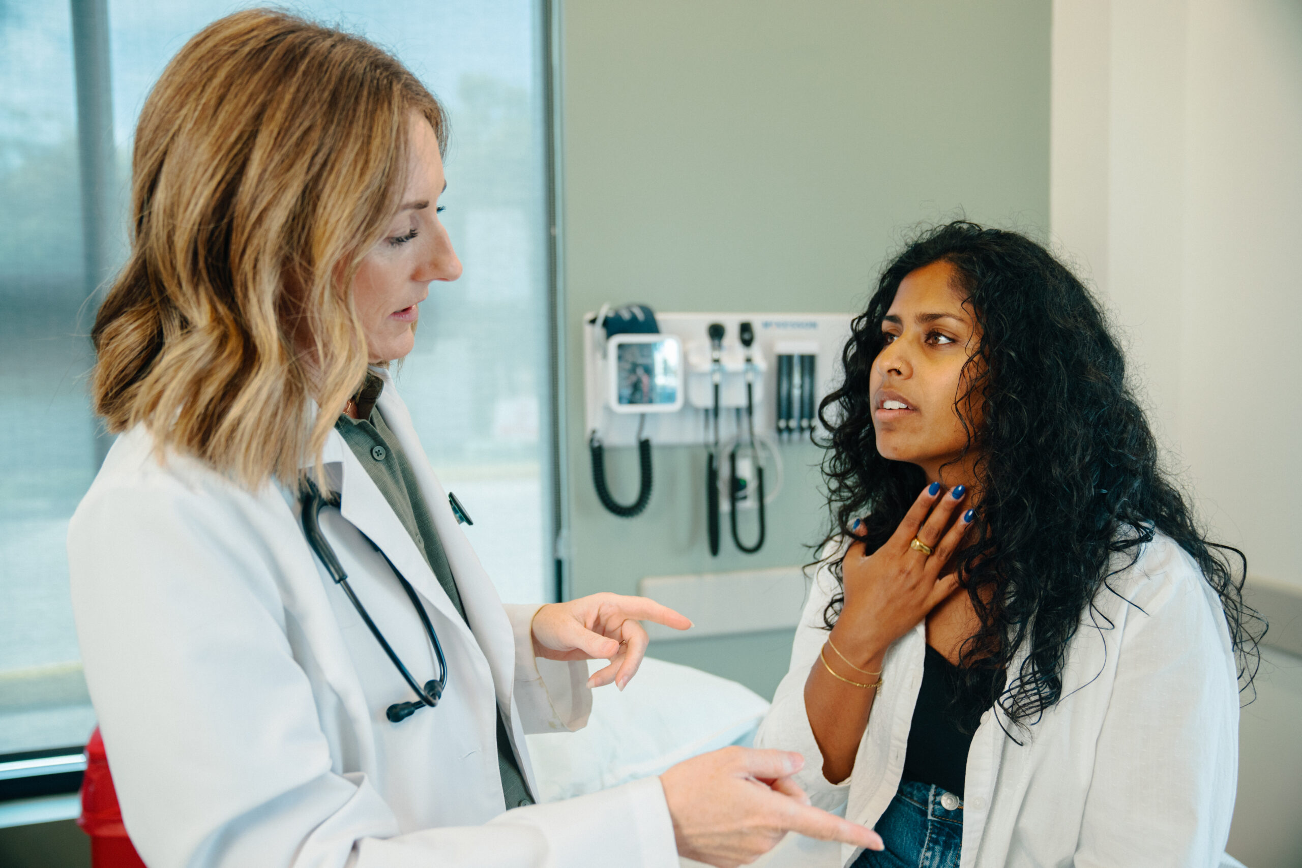 Female patient discusses strep throat pain with AFC provider